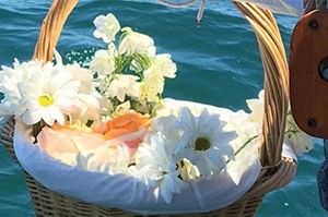 A basket dressed with an add-on flower arrangement
